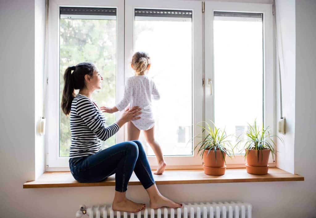 women and child looking out a new window