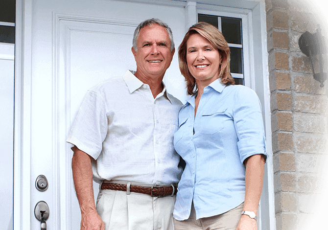 homeowners in front of a new door