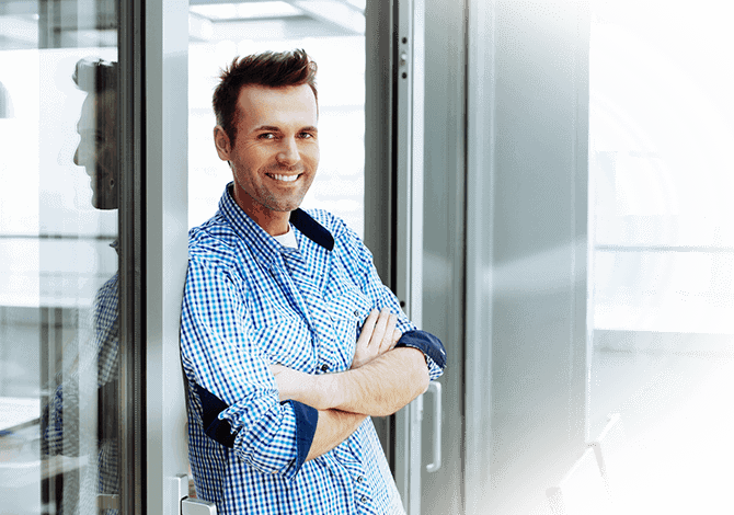 middle aged man standing in front of new doors